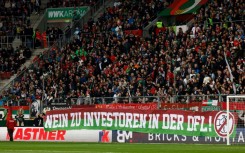 Football fans protest a huge capital injection investor deal, unfurling banners and raining tennis balls on pitches