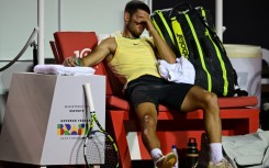 Spain's Carlos Alcaraz gestures after suffering an ankle injury in his ATP Rio Open first-round match against Thiago Monteiro