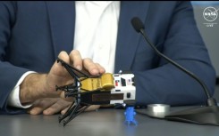 This frame grab from Nasa, shows Intuitive Machines CEO Steve Altemus holding a model of Odysseus to show its position on the side 