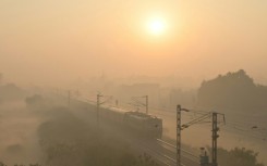 A train passes through heavy smog in India, where authorities have ordered an investigation into a runaway train incident