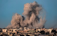 This picture taken from Rafah in the southern Gaza Strip shows smoke billowing during Israeli bombardment on Khan Yunis on February 22, 2024