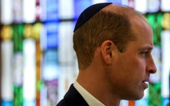 Prince William wears a kippah during a visit to the Western Marble Arch Synagoguein London