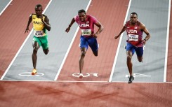 Jamaica's Ackeem Blake (L), Noah Lyles (C) and Christian Coleman (R) cross the finish line of the 60m