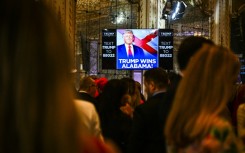 Supporters of former US President and 2024 presidential hopeful Donald Trump watch a screen announcing "Trump wins Alabama" as they attend a Super Tuesday election night watch party at Mar-a-Lago Club in Palm Beach, Florida, on March 5, 2024