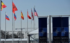 An empty mast is seen among member-nations at the NATO headquarters, ahead of a flag-raising ceremony for new member Sweden