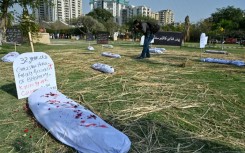 Paint-spattered bodybags represent the toll of violence against women in Karachi, Pakistan