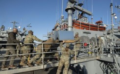 US Army soldiers load an AC unit aboard the USAV Monterey on March 12, 2024 ahead of the vessel's departure for an operation to construct a temporary port on Gaza's coast