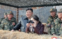 Kim Jong Un's daughter Ju Ae peers through binoculars at a recent training exercise involving North Korean paratroopers