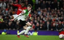 Manchester United substitute Amad Diallo (L) scores the winning goal against Liverpool in an FA Cup quarter-final.
