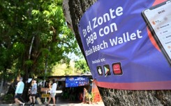 A sign promoting bitcoin transactions is seen in the beach town of El Zonte in El Salvador