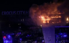 Attackers dressed in camouflage uniforms entered the building, opened fire and threw a grenade or incendiary bomb, according to a journalist at the scene