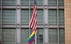 The rainbow flag flies under the US flag at the entrance to the US embassy in Moscow in June 2021