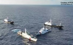Aerial video footage shows a China Coast Guard ship (2nd L) and vessels identified by the Philippine Coast Guard as 'Chinese maritime militia' (L and R) surrounding the Philippine ship BRP Cabra
