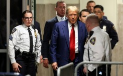 Former US president Donald Trump arrives for a hearing to set a date for his trial for allegedly covering up hush money payments to  a porn star