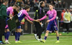 Germany midfielder Florian Wirtz shakes hands with Thomas Mueller in Tuesday's 2-1 win over the Netherlands in Frankfurt
