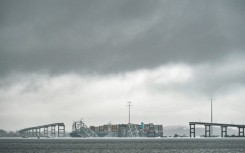 The Dali, a Singaporean-flagged cargo vessel that spans the size of almost three football fields, remains stuck under debris from the Francis Scott Key Bridge on March 27, 2024 after the ship crashed into the bridge in Baltimore, Maryland