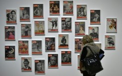 A woman looks at LIFE magazine copies as part of the show "Sorprendeme!", a retrospective of Philippe Halsman at CaixaForumin Madrid, November 30, 2016