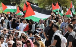 Arab citizens of Israel wave Palestinian flags as they demand an end to the Gaza war at an annual commemoration