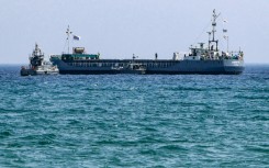 A Cyprus coastguard vessel approaches the aid ship Jennifer off Larnaca ahead of its departure for Gaza
