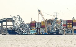 The container ship Dali is seen pinned under fallen wreckage of the Francis Scott Key Bridge in Baltimore, Maryland on March 30, 2024 