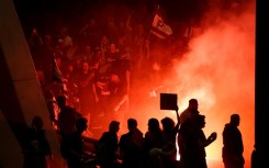 Demonstrators blocked a main city highway, lighting fires and waving Israeli flags