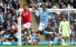 Yellow card complaint: Manchester City defender Manuel Akanji (R) in action against Arsenal's Gabriel Jesus (L) 