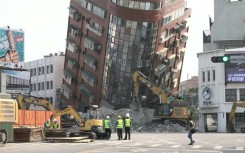 Emergency crews work near heavily-tilted building in Hualien after Taiwan quake