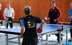 People play table tennis at the Ping Pong Parkinson initiative in Berlin on April 11, 2023, World Parkinson's Day -- the devastating disorder affects 10 million people worldwide