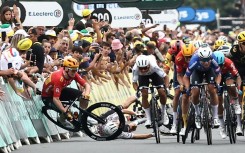 Norwegian rider Soren Waerenskjold (L) crashes during a sprint finish in the 2023 Tour de France