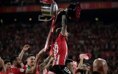 Athletic Bilbao captain Iker Muniain raises the trophy after winning the Copa del Rey against Mallorca on penalties