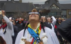 Despite cloudy skies, thousands of people flock to Niagara Falls in Canada to witness a rare total solar eclipse