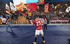 Gianluca Mancini waves a flag depicting a rat in front of Lazio colours after Saturday's Rome derby