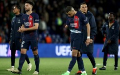 Kylian Mbappe walks off the pitch with PSG teammates after the French side's 3-2 defeat by Barcelona in the first leg of their Champions League quarter-final tie