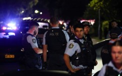 Police gather outside the Christ the Good Shepherd Church in Sydney's western suburb of Wakeley on Monday night