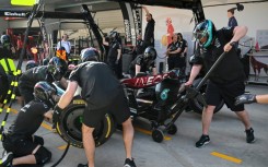 Mechanics practice pit stops with the car of Mercedes' British driver Lewis Hamilton ahead of the Formula One Chinese Grand Prix in Shanghai