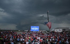 Supporters of Republican presidential candidate Donald Trump await his speech under the threat of a storm at a campaign rally in Wilmington, North Carolina, on April 20, 2024. The event was eventually called off because of weather