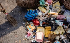 Lagos State Waste Management Authority (LAWMA) staff cleans up piled up waste from the road side at Ikoyi in Lagos on January 2024
