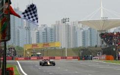 Red Bull Racing's Dutch driver Max Verstappen takes the chequered flag in Shanghai