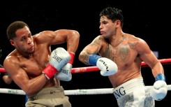 Ryan Garcia (white trunks) punches Devin Haney (gray trunks) on the way to a majority decision victory in their super-lightweight bout in Brooklyn, New York