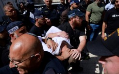 Israeli police detain a man at the site of a reported ramming attack in Jerusalem