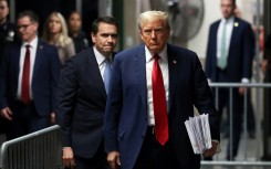 Former US President Donald Trump, with attorney Todd Blanche (L), walks toward the press to speak after attending his criminal trial for alleged business record fraud