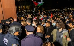 New York Police Department officers detain pro-Palestinian students and protesters who had set up an encampment on the campus of New York University to protest the Israel-Hamas war