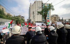 Palestinian Authority police prevent demonstrators from reaching the Canadian Representative Office in the occupied West Bank