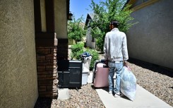 A man and his family gather their belongings after being evicted from a residential property