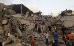 Gazans search through the rubble following Israeli strike on Deir El-Balah