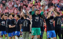 Girona players celebrate their qualification for the UEFA Champions League at the end of beating Barca at Montilivi
