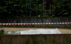 A body covered with a sheet after a double shooting in Sevran, northeast of Paris, on Sunday