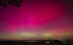 Northern Lights, or aurora borealis, illuminate the night sky near London, Ontario, during the most powerful solar storm in more than two decades