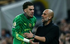 Reluctant to come off: Manchester City goalkeeper Ederson (L) argues with manager Pep Guardiola while being substituted during a 2-0 win over Tottenham Hotspur