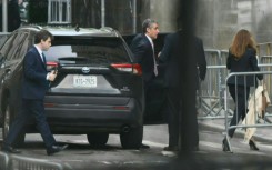 Former Trump attorney Michael Cohen (C) arrives at Manhattan Criminal Court for the trial of former US President Donald Trump for allegedly covering up hush money payments linked to extramarital affairs